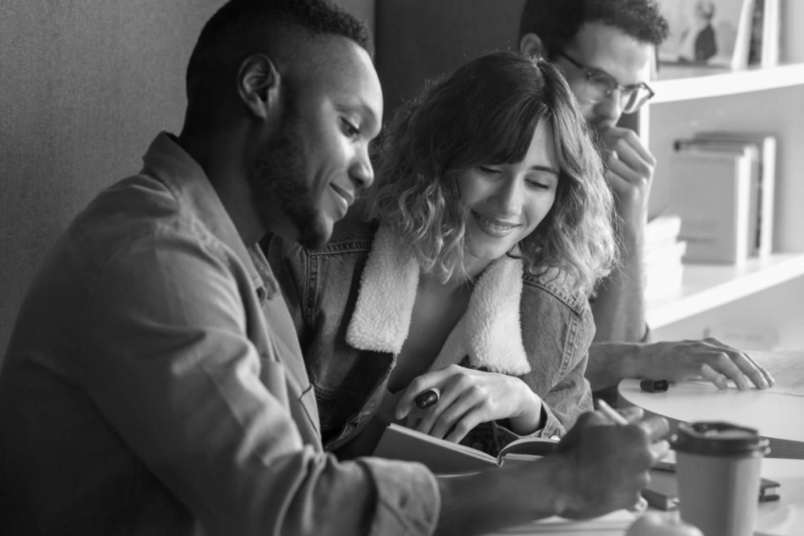 Person reviewing financial documents and budget sheets at a desk with calculator and charts