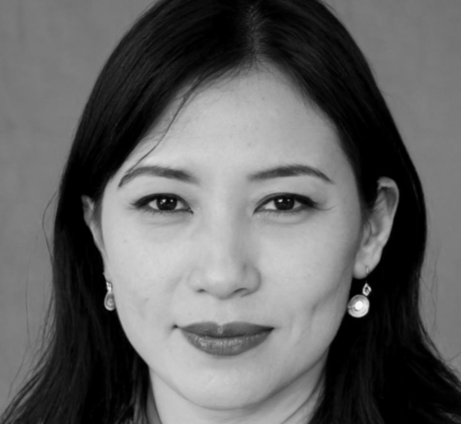 Professional woman with dark hair smiling confidently